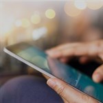 Close up of hands using tablet device