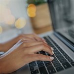 Close up of hands using laptop